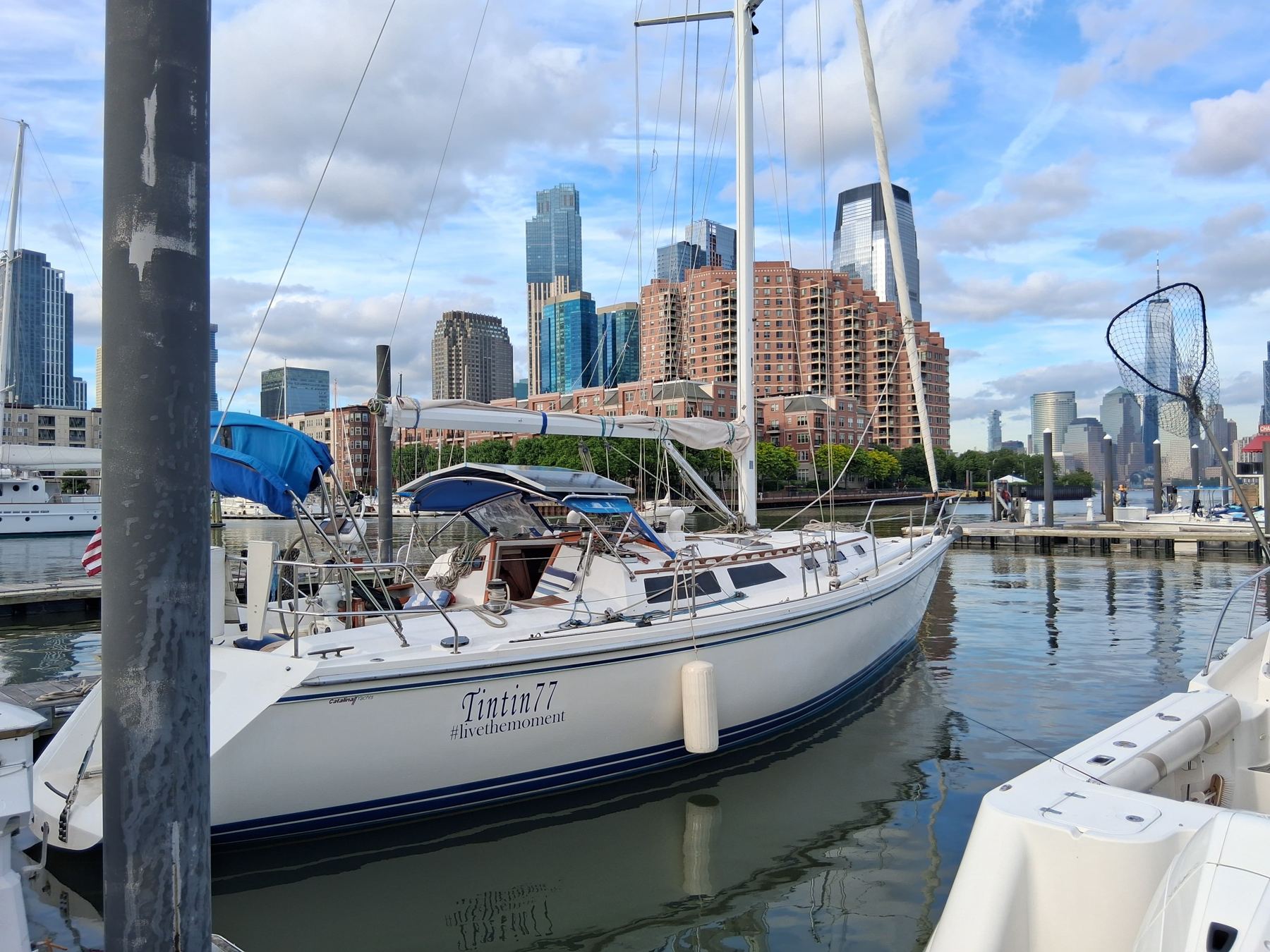 TinTin77 in her slip facing the Jersey City and Manhattan skyline